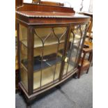 A bowfront mahogany display cabinet, shaped gallery, gadrooned border to top, astragal glazed