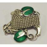 Georg Jensen style a Danish silver and enamel pierced brooch, a lamb with green enamel leaves