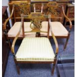 Three painted satinwood regency style open arm chairs, lyre shaped splat decorated with arrows and