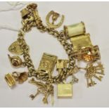 A 9ct gold charm bracelet, 9ct gold heart shaped padlock, with 15 charms including passport, church,