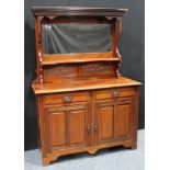A 20th century mahogany mirrored back sideboard, outswept cornice above a rectangular mirror and a
