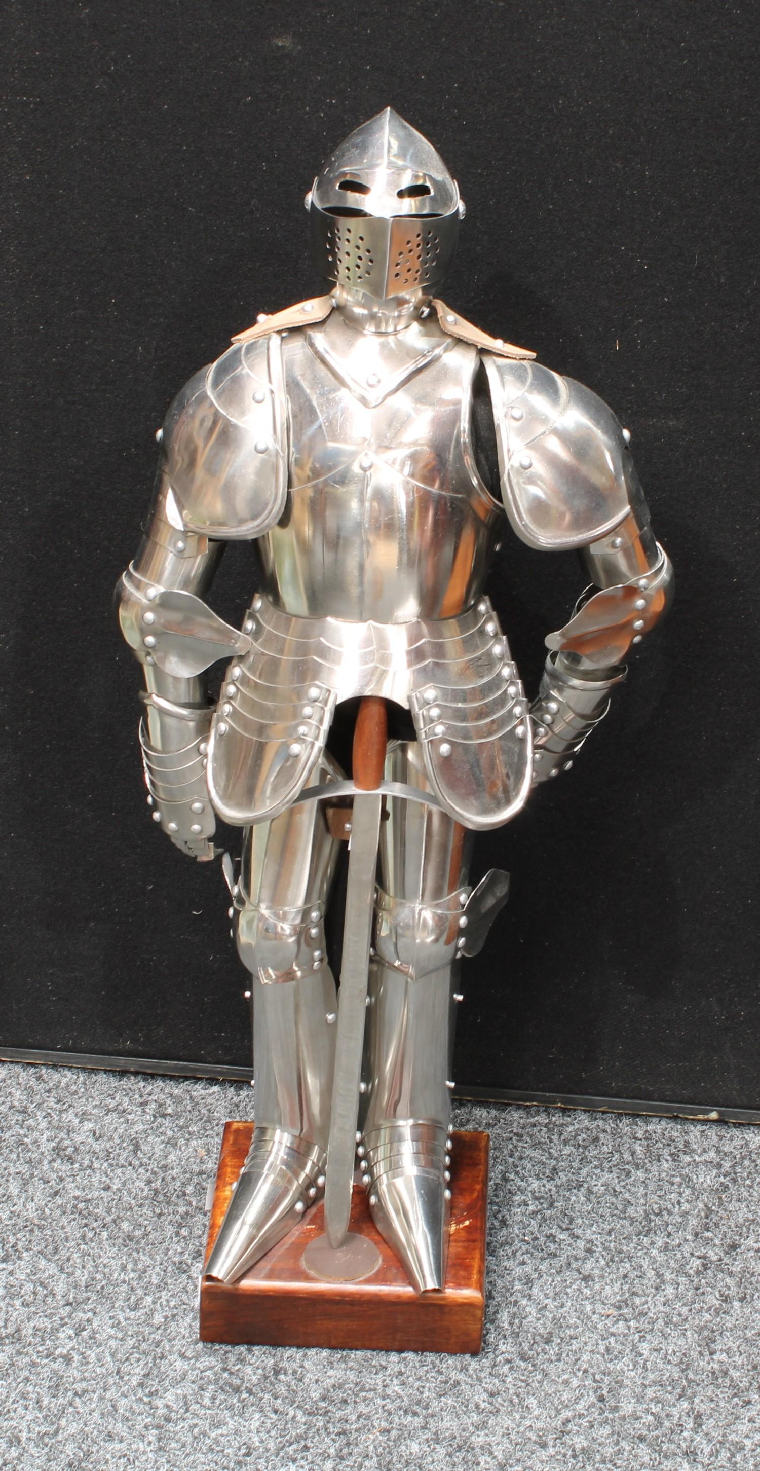 A model of a medieval knight in shining armour, wooden plinth. 72cm