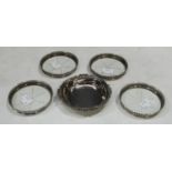 A set of four sterling silver and clear glass coaster; a small tray, marked silver (5)