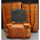 A Beautility walnut three-piece bedroom suite, comprising two wardrobes and a dressing table (3)