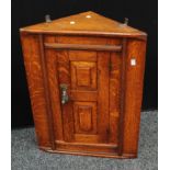 An oak corner cupboard, of small proportions,63cm high.