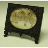 A 19th century Indian carved ebony easel frame set with an oval minitature on ivory depicting a