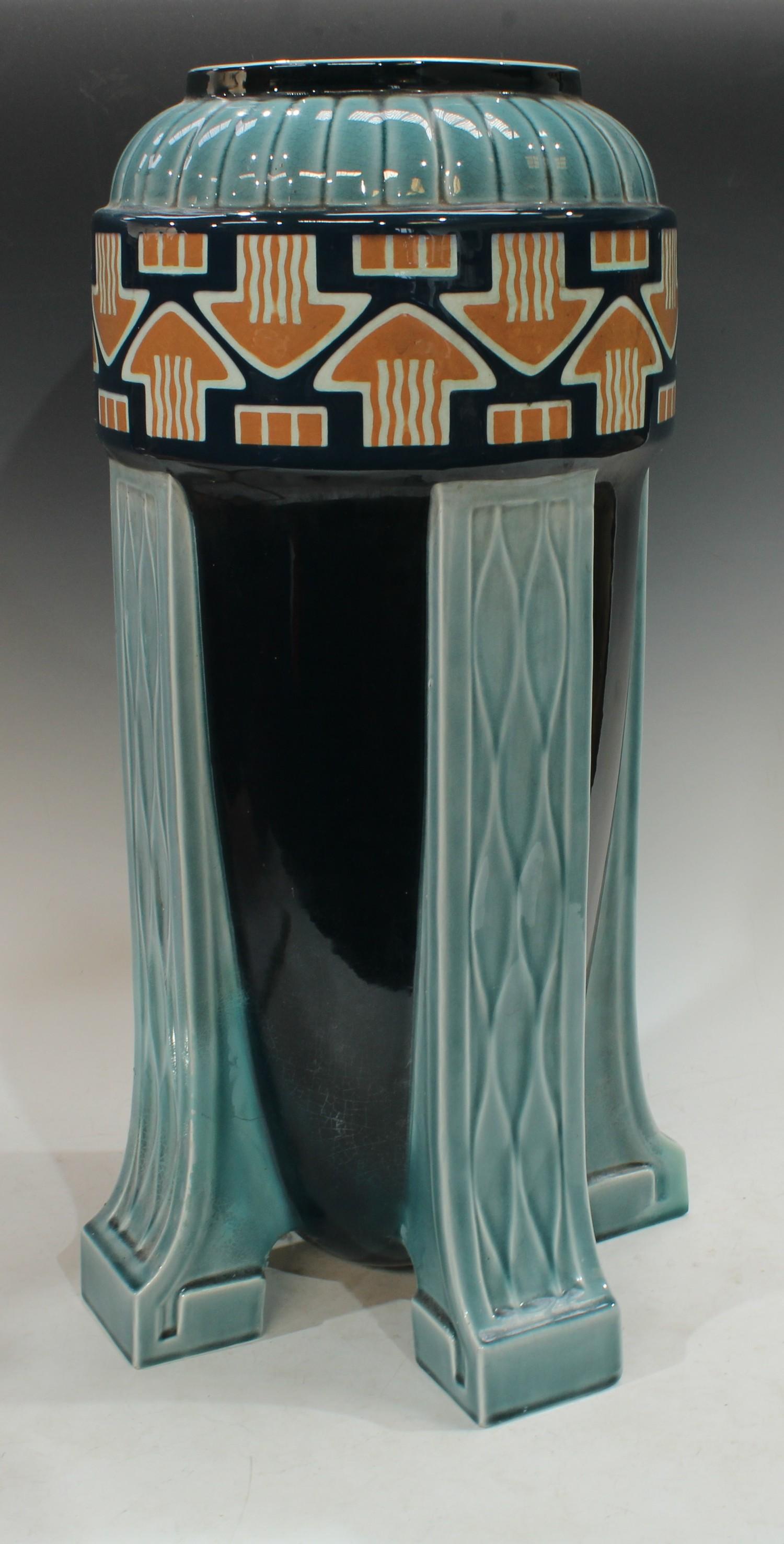 A continental Art Deco bullet shaped umbrella/stick stand, applied with a band of arrow motifs,