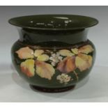 A late 19th century Langley Ware jardiniere, decorated with flowers in tones of yellow and pink,