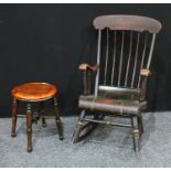 A 20th century painted ebonized American rocking chair; Another stool.(2)