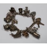 A silver curb link charm bracelet, assorted charms, pianist, cine camera, magic lantern, rocking