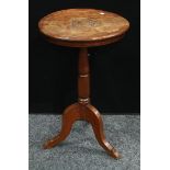 An unusual early 19th century oak tripod table, the centre carved with acorns and oak leaves, In