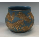 A late 19th century Langley Ware jardiniere, incised decoration picked out in gilt on a blue ground,