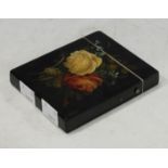 A Victorian black laquer visiting card case, hinged cover, applied with a decoupage floral spray