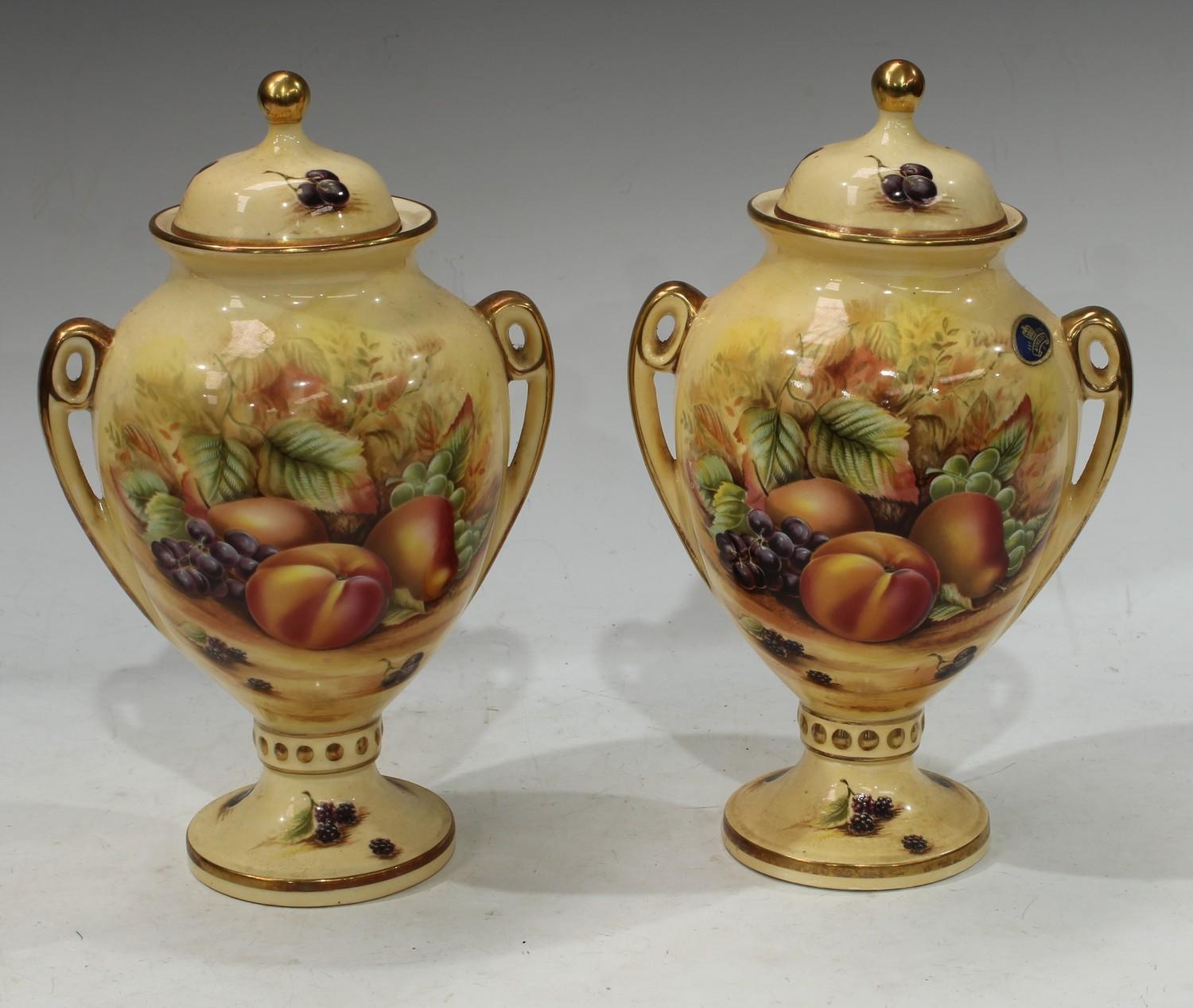 A pair of Aynsley Orchard Gold pedestal urns and covers, 22.5cm high (2)