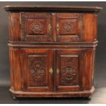 An 18th century Spanish side cabinet, stepped cornice above a pair of raised and fielded panel doors