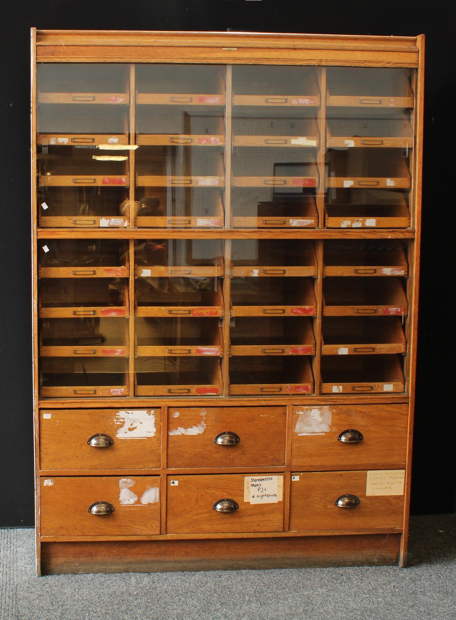 Industrial Salvage - an early 20th century haberdashery shop display cabinet, two rows of sliding
