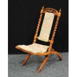 A 19th century mahogany Arts and Crafts folding cottage chair, pierced cresting rail, barley twist