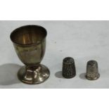A hallmarked silver thimble, engraved Nellie Little; another, similar; a hallmarked silver eggcup