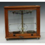 A set of scientific laboratory balance scales, by Phillip Harris Ltd, Birmingham, glazed cabinet,