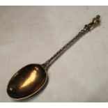 A mid-Victorian parcel-gilt silver 'Apostle' table spoon, the figural finial cast as a rotund