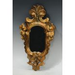 A Baroque style giltwood cartouche shaped looking glass, 44cm x 26cm