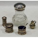 A silver three piece cruet set, blue glass liners, Birmingham 1924; a silver mounted cut glass sugar