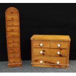 A hardwood chest of unusual proportions, dome shaped top above ten short drawers,139cm high; a