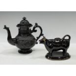 An early 19th century Jackfield type black glazed teapot, inverted pear shape, moulded with floral