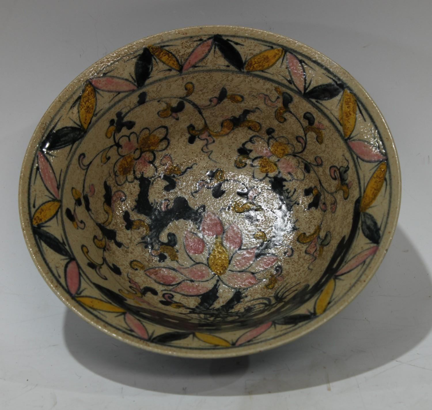 A Chinese circular celadon type glazed bowl, painted with lotus flowers, character mark, 17cm