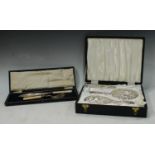 A silver three piece dressing table hand mirror and brush set, Birmingham 1972, boxed; a set of EPNS