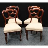 A set of four Victorian mahogany dining chairs, stuffed over upholstery, turned legs.(4)