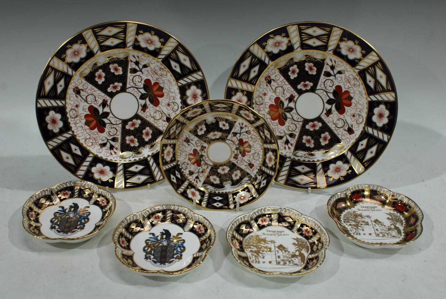 A pair of Royal Crown Derby 2451 pattern side plates; a pair of five petal commemorative pin