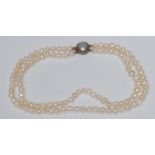 A diamond mounted free form cultured pearl two strand necklace, two strands of creamy grey white