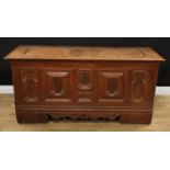 An 18th century North European oak blanket chest, hinged top with shaped raised panels, the front