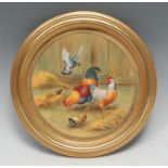 An English porcelain circular plaque, painted by F Clark, signed, with cockeral, chicken, chicks and