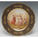 A Vienna shaped circular plate, signed Riemer with Tanzende Grazien, Dancing Graces, within cobalt