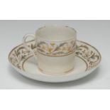 A Pinxton coffee can and saucer, pattern 275, decorated with scrolling leaves in tones of grey and