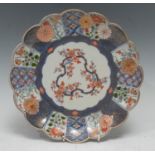An early 18th century Japanese porcelain Mosaic pattern shaped circular plate, the powder blue