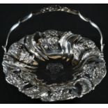 A William IV silver fluted shaped circular swing handled cake basket, chased with sunflowers and