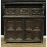 A 17th century oak duodarn, spirally fluted frieze above three doors applied with geometric