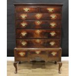 A George III oak chest on stand, outswept cornice above two short and four long graduated drawers,