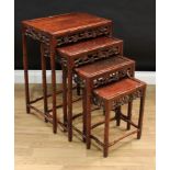 A set of Chinese hardwood quartetto tables, rectangular panel tops, carved throughout with leafy