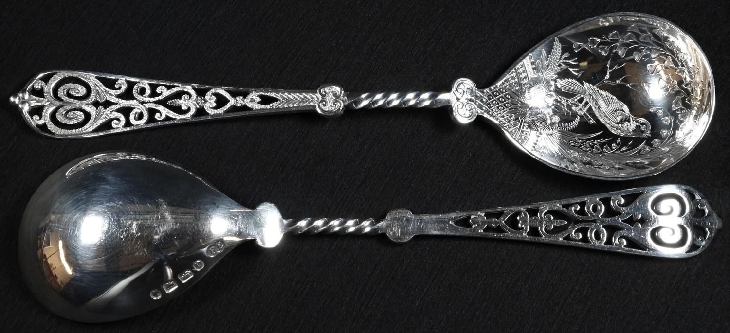 A pair of Victorian Aesthetic Movement silver serving spoons, each bowl well engraved with