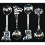 A set of four silver novelty salt spoons, the terminals as the head of an owl, a bull, and dogs,
