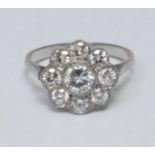 A diamond floral cluster ring, central round brilliant cut diamond approx 0.46ct, surrounded by a