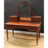 A large Victorian mahogany dressing table, arched mirror above two pairs of small drawers, the