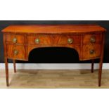 A George III mahogany bow-fronted sideboard, slightly oversailing top above a long frieze drawer