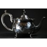 An Edwardian silver teapot, hinged domed cover, scroll capped handle, wavy border, shaped pad