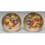 Two Royal Worcester circular pin dishes, painted by Roberts, signed, with ripe fruit on a mossy