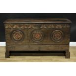 An unusual 18th century oak chest, of boarded construction, rectangular top the front carved with
